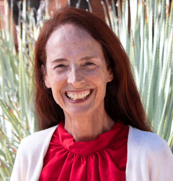 Ashiko Rupp in a red blouse and white cover smiling at the camera