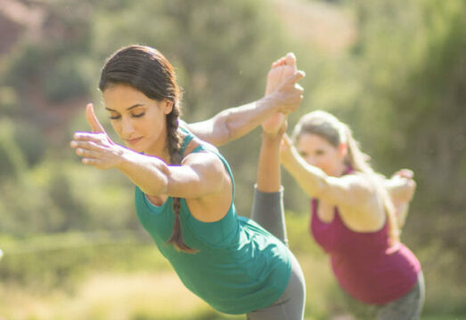 Two women practicing yoga on the grounds of our luxury Sedona spa