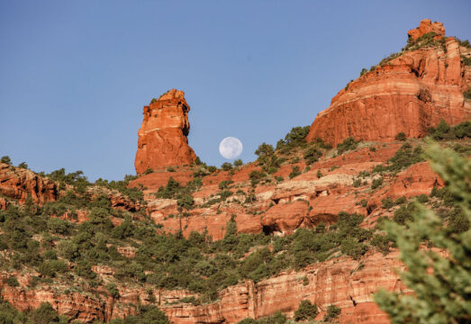 moon rising over the Boynton Canyon red rock walls surroundning Mii amo