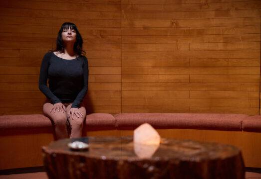 woman meditating in the crystal grotto at Mii amo