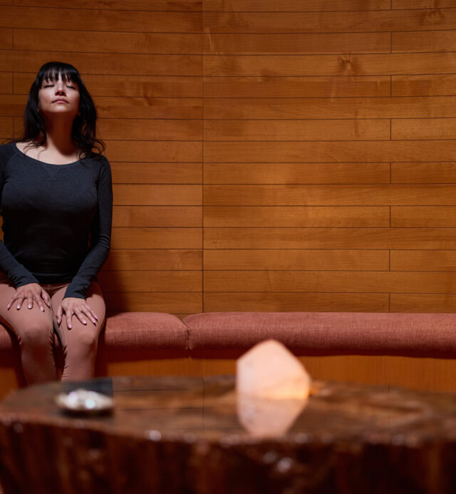 woman meditating in the crystal grotto at Mii amo