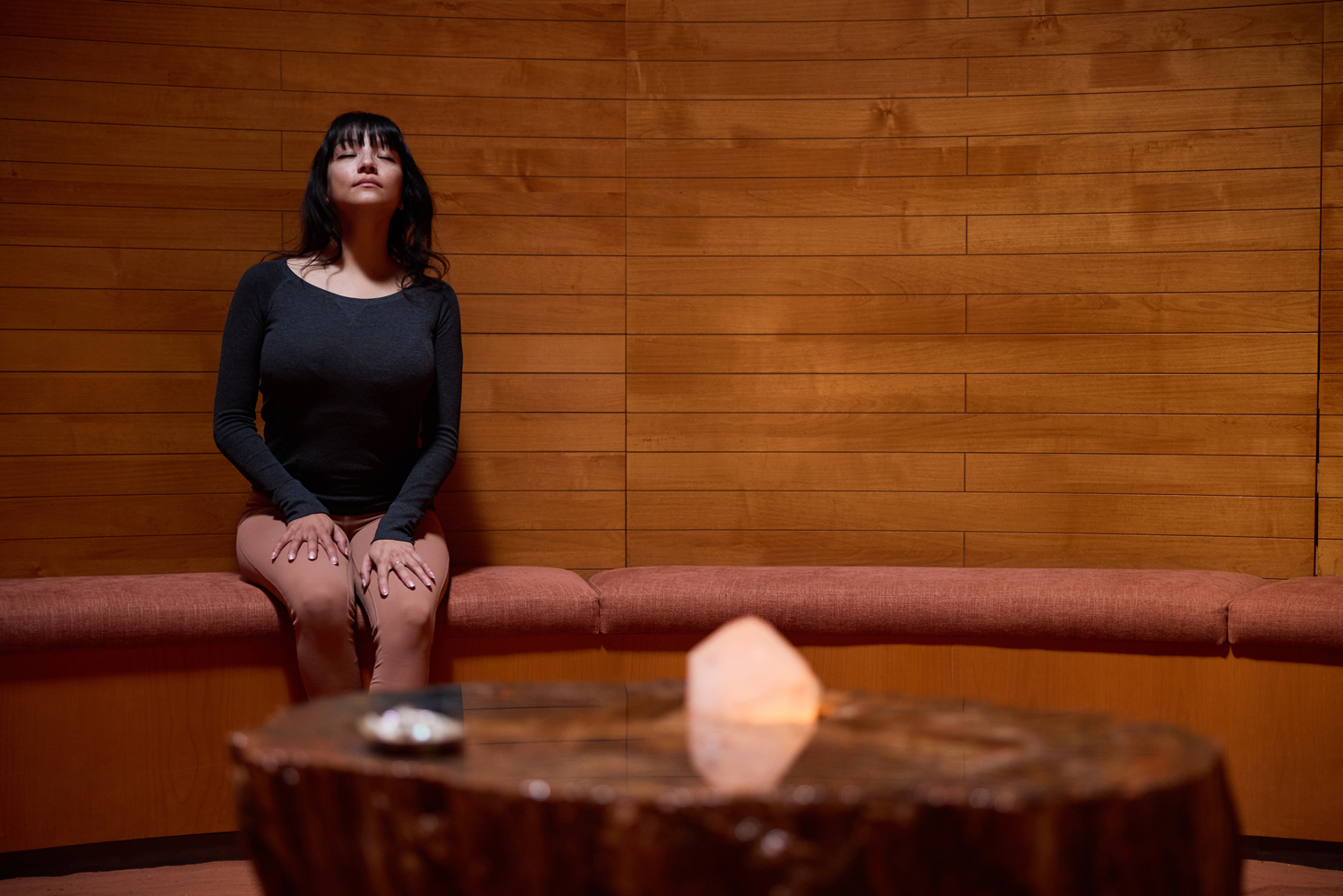 woman meditating in the crystal grotto at Mii amo